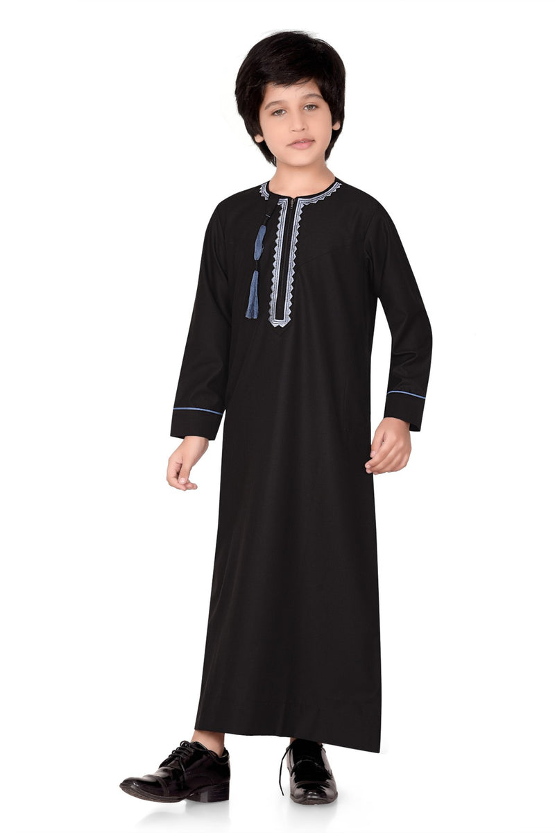 Black long-sleeve thobe for children, featuring blue embroidery and a tassel detail By Zamzam